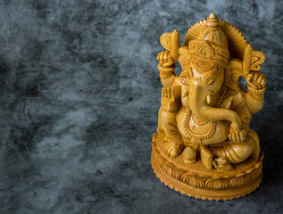 Fototapeta na wymiar Ganesha statue on a grey stone background