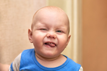 Portrait of a funny boy who grimaces