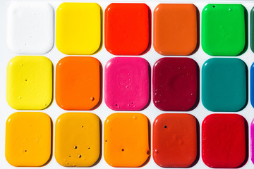 Multi-colored bright Watercolor paints close up. A background from paints