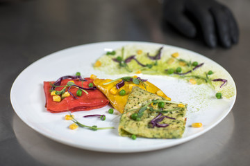 Pancakes of different color on a plate. We prepare with children
