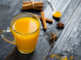 tea with turmeric on a dark wooden background