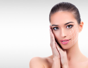 Pretty woman against a grey background with copyspace. Skin care concept