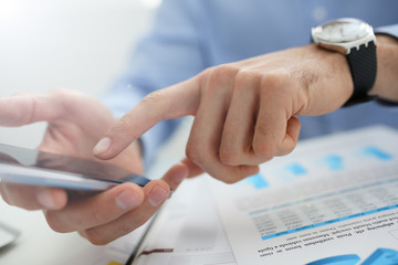 businessman holds a new smartphone in his hand