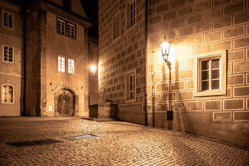 Medieval houses and old drinking fountain in Golden Lane by night, Prague Castle, Czech Republic