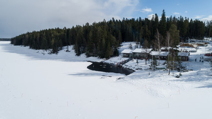 Public lakeside sauna. People are swimming in huge ice hole after sauna. Ice swimming.