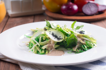 Healthy salad.  Zucchini, fresh vegetables and walnut sauce.  Vegetarian. Diet food. Wooden background