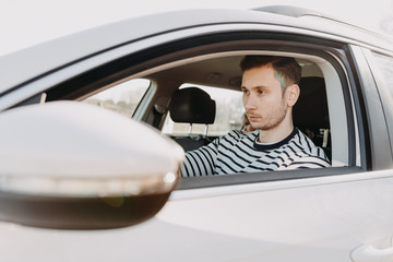 Attractive man driving white car