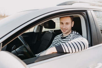Attractive man driving white car