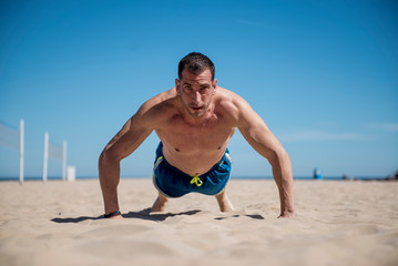Fototapeta na wymiar Attractive man doing sport on the beach