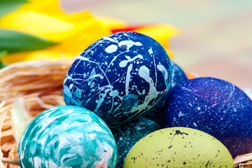 Easter eggs and tulips on wooden planks