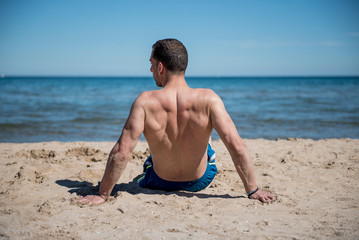 Fototapeta na wymiar Attractive man posing on the beach