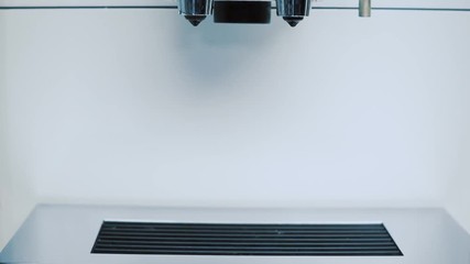 Woman grabbing coffee from coffee machine.