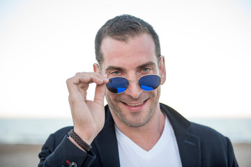 Attractive man posing on the beach