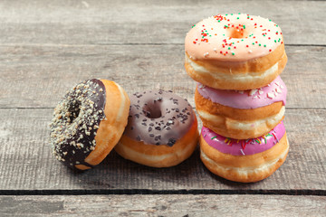 Glazed donuts on wooden background