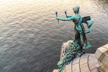 Torch bearer woman figure - bronze decoration of Svatopluk Cech Bridge over Vltava River in Prague,...