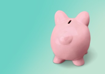Pink ceramic piggy bank with copy space alongside in a conceptual financial image