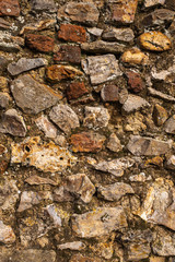A close up of a wall made of large rocks and cement, great for a background or wallpaper