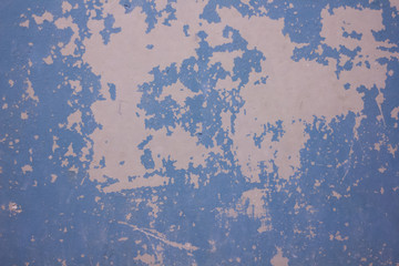 Obraz premium The texture of the wall with cracked blue paint. Cracked wall background