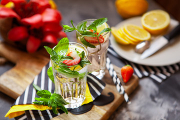 Refreshing summer beverage with lemon, mint and ice. Glasses with cold and healthy drink, place for text - obrazy, fototapety, plakaty