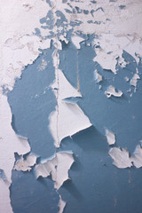 The texture of the wall with cracked blue paint. Cracked wall background