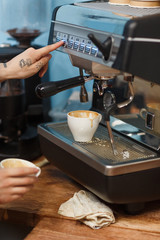 Barista makes coffee on a professional coffee machine