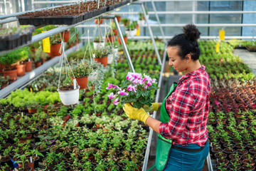Black woman working in a botanical garden