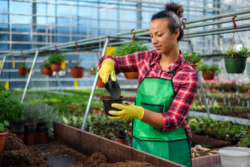 Black woman working in a botanical garden
