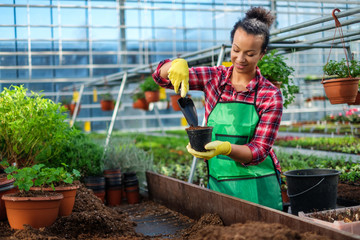 Black woman working in a botanical garden