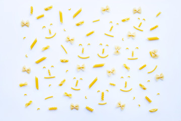 Different types of dry pasta on white.