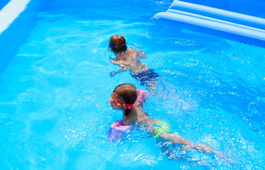 boy and girl swimming in the pool in the Villa