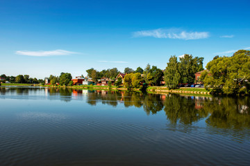 The image of the village behind the lake in Russia