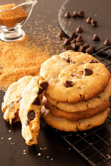 Homemade salted caramel chocolate chips cookies. Dark background.