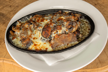 Sous vide (low temperature cooking) beef tongue with cheese and mushrooms.