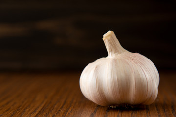 Garlic bulb on the wooden vintage background