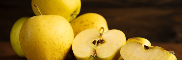 Yellow apple on the wooden vintage background