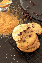 Homemade salted caramel chocolate chips cookies. Dark background.