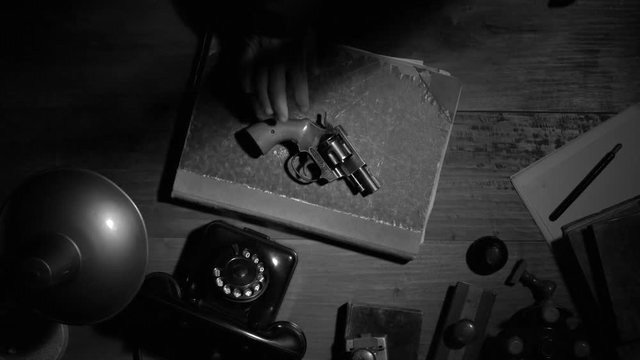 Noir film vintage agent putting the revolver on a desk