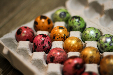 Fototapeta na wymiar top view on the eggs decorated in various colors by Easter holiday