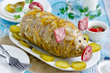 Russian dish holodets, headcheese, pork meat jelly, aspic in bottle shaped funny pig decorated with salami sausage and black pepper