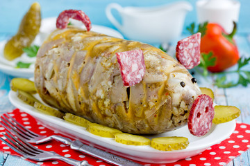Russian dish holodets, headcheese, pork meat jelly, aspic in bottle shaped funny pig decorated with salami sausage and black pepper