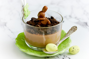 Easter treat idea chocolate mousse dessert in glass with chocolate cookie crumbs and chocolate...