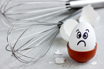 Sad egg with painted face as a allegory culinary mistakes
