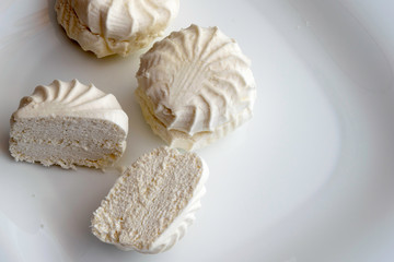 fresh white marshmallow lies on white plate