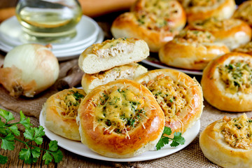 Homemade dinner buns stuffed with minced meat and cheese. Round meat patties from yeast dough for snack. Cheese meat pizza pies