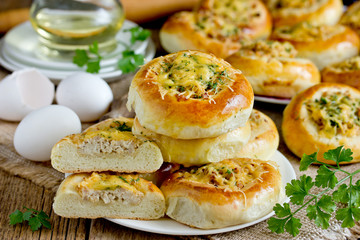 Homemade dinner buns stuffed with minced meat and cheese. Round meat patties from yeast dough for snack. Cheese meat pizza pies