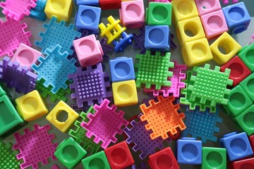 Pile of colored toy bricks isolated on white background 