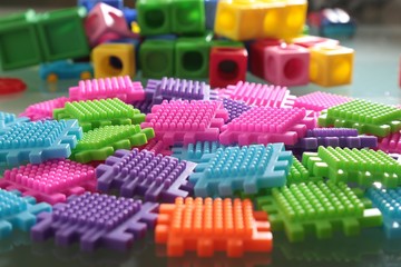 Pile of colored toy bricks isolated on white background 