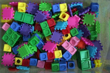Pile of colored toy bricks isolated on white background