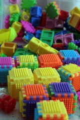 Fototapeta na wymiar Pile of colored toy bricks isolated on white background 
