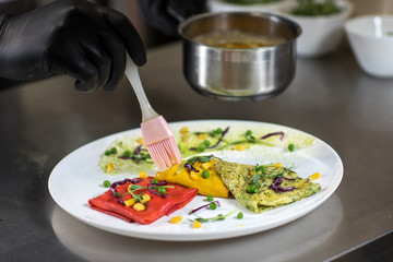 Pancakes of different color on a plate. We prepare with children